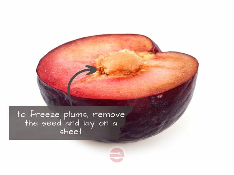 plum cut in half ready for freezing